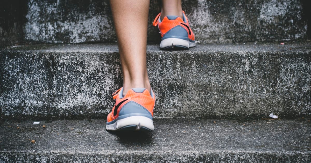 Man trail running outdoors as part of a sustainable fitness routine